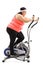 Tired overweight woman exercising on a cross trainer machine