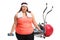 Tired overweight woman exercising with small dumbbells in front