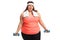 Tired overweight woman with small dumbbells and a towel