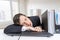 Tired overworked man is sleeping on keyboard in office at work