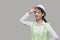 Tired overworked young Asian woman worker wiping sweat posing on gray isolated background.