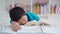 Tired preteen boy sleeping after reading book