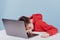 Tired preteen boy sleeping on table near laptop