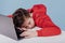 Tired preteen boy sleeping on table in studio