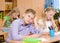 Tired schoolboy in classroom