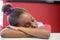 Tired schoolgirl sleeping in classroom