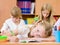 Tired schoolgirl writes in a notebook during lesson