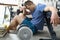 Tired from sports exercises guy sits floor at home