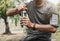 Tired Sports man opening a bottle of water with nature background