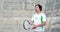 Tired sportsman standing with racket