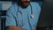 Tired stressed physician nurse wearing blue uniform and stethoscope
