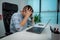 Tired or stressed young businessman sitting in front of computer in office