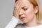 Tired stressful woman having strong tension headache or head migraine