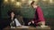 Tired teacher and female student sitting on the table communicate and solve problems. Contemplative young professor and