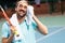 Tired tennis player with towel after training on tennis court