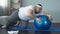 Tired unmotivated obese man lying on fitness ball, slimming fitness program