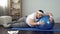 Tired unmotivated obese man lying on fitness ball, slimming fitness program
