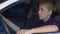 Tired upset female cop sitting in patrol car, pondering difficult investigation