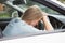 Tired woman asleep on steering wheel