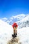 Tired woman climbing and hiking in winter mountains