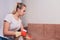 Tired woman having rest after cleaning home, lying on sofa in the living-room, copy space. Housekeeping and home