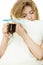 Tired woman holding toothbrush and coffee