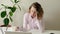 Tired woman laid her head down on the table. Tired Woman with Headache while sitting at her working place in office