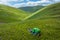 Tired woman lying in grass at mountain