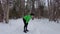 Tired woman runner resting after workout breathing taking a break from winter running in forest with snow.. Fitness