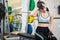 Tired woman sitting on barbell bench