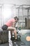 Tired woman sitting on tire in crossfit gym