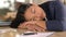 Tired woman sleeping on her desk in office with depression, burnout and mental health risk for project deadline or