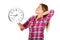 Tired woman stretches and holding a clock