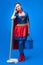 tired woman in superhero costume with mop and bucket for cleaning