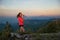 Tired woman trail runner drinking water