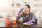 Tired woman using spray cleaner on wooden surface