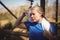 Tired woman wiping sweat after workout during obstacle course