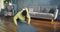 Tired woman in yellow hoodie does push ups standing on knees