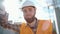 A tired worker at a construction site rests his hand on the wall after hard work and is under stress. Close-up