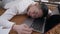 Tired young Chinese man yawning lying on laptop keyboard napping in home office. Exhausted overworked Asian guy sleeping