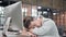 Tired Young Guy having Quick Nap at Office Desk