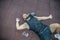 Tired young man lying on floor and relaxing in gym after training. Male relaxing after workout session at gym