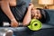 Tired young man sleeping on sofa by holding dumbbells and yoga mat - concept of healthcare, lifestyle and fitness man