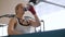 Tired young woman boxer drinking cold water from a bottle after strong training