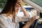 Tired young woman car driver suffer from headache or migraine pain inside vehicle touch forehead