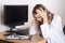 Tired young woman doctor sitting in office