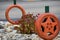 Tires painted orange to look like pumpkins for fall decoration.