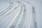 Tires track on white snowy road in winter