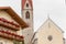 TISO, ITALY - SEPTEMBER 12, 2017: The clock and its sundial painted and recently restored outside the bell tower of the church