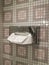 Tissue Stainless box hanging on vintage marble tile wall in toilet at home or hotel with blur bathroom wall background, household